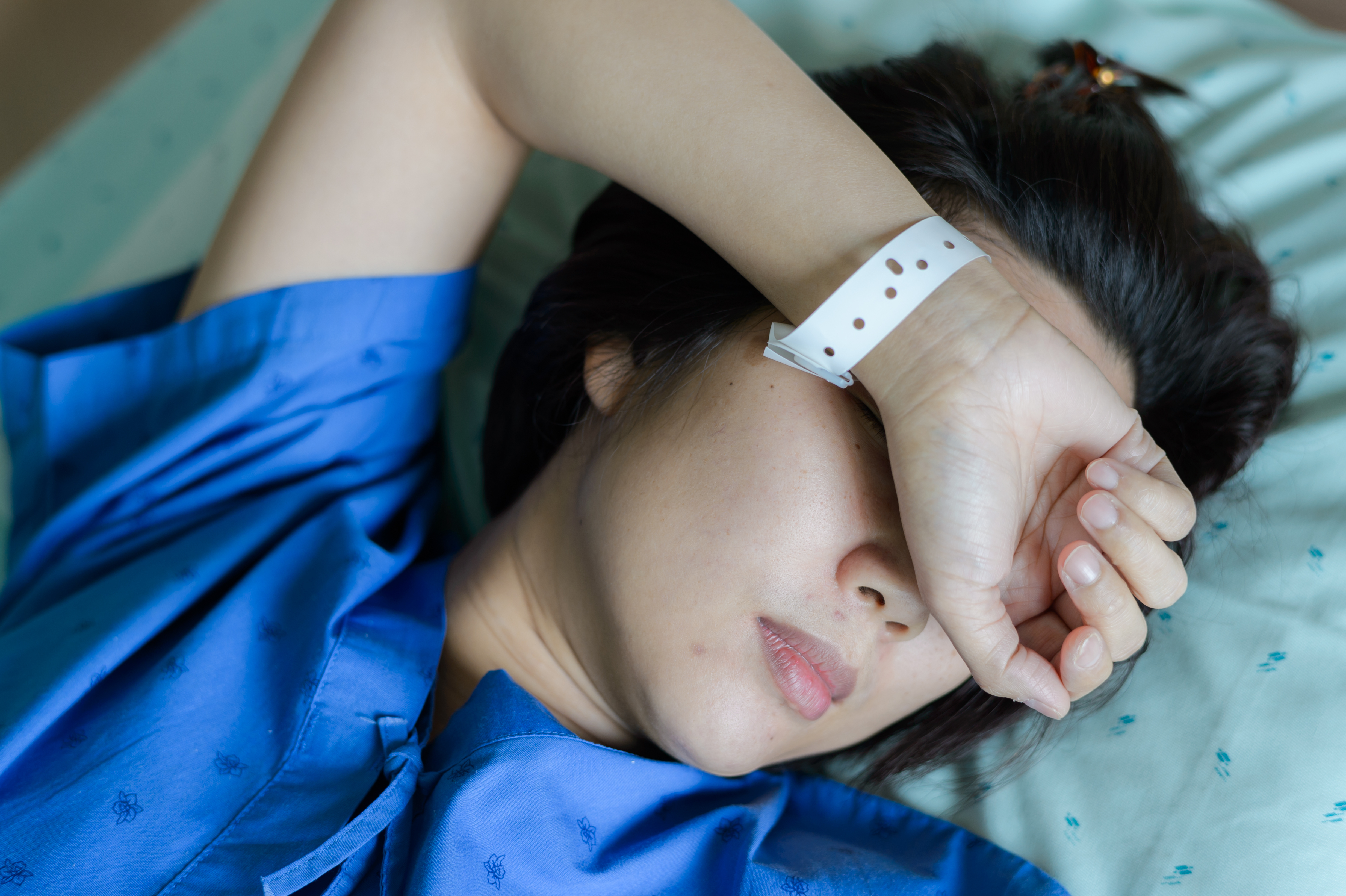 Asian,Woman,Patient,Sleeping,In,Hospital,Bed
